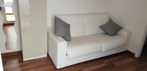 a white couch with two pillows on it at Il sogno di Ele in Polignano a Mare