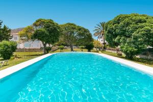 a large swimming pool with blue water at Apartment Rosmare III in Alcudia