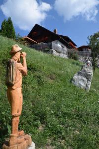 a statue of a man talking on a cell phone at Farm Stay "Alpine Dreams" in Solčava