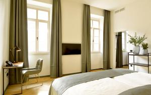 Krevet ili kreveti u jedinici u okviru objekta Hotel Maribor & Garden Rooms