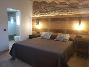 a bedroom with a bed with two pillows on it at Les Muntades in Jorba +32 photos