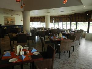 a dining room with tables and chairs in a restaurant at Sun & Sands Sea View Hotel in Dubai