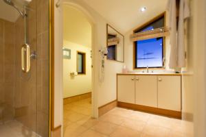 a bathroom with a shower and a sink at The Wheelhouse Inn in Nelson