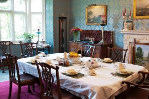 a dining room with a table with food on it at Lullington House in Frome