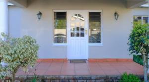 a white front door of a white house at Retreat in Hillcrest