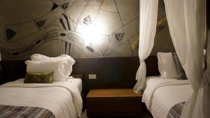 Postel nebo postele na pokoji v ubytování Bamboori Boutique Resort