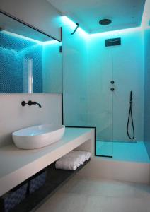 a bathroom with a sink and a glass shower at MADA Charm Apartments Terrace&Carugio in Vernazza