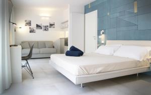 a bedroom with a white bed and a blue wall at MADA Charm Apartments Terrace&Carugio in Vernazza