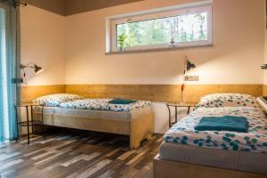 Postel nebo postele na pokoji v ubytování Apartmány Pod Lesem II