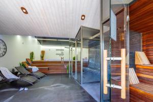a living room with a glass wall at Hôtel Restaurant & Spa Plaisir in Le Bois-Plage-en-Ré