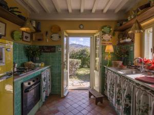 a kitchen with a sink and a door to a yard at Belvilla by OYO La Noce in Cortona