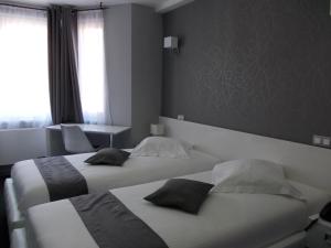 Vuode tai vuoteita majoituspaikassa Hotel Phenix