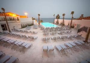 an empty patio with chairs and a swimming pool at Spirit Hotel Benalmadena Beach in Benalmádena