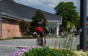 a man riding a bike with a red backpack at Pension Haus Saarland in Oberhof