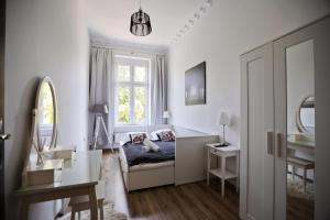 a white living room with a couch and a window at Apartments Old Town Gdansk - Toruńska 26 in Gdańsk