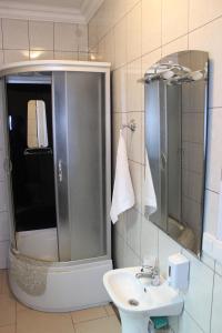 a bathroom with a shower and a sink at Мини готель in Ternopil