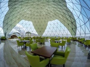 a restaurant with tables and chairs and a glass ceiling at Petra Bubble Luxotel in Wadi Musa +53 photos