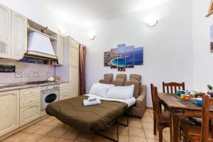 a kitchen with a couch and a table in a room at Pilly House Vucciria in Palermo