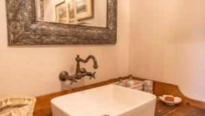 a bathroom with a white sink and a mirror at Glamping Bothie in Inverurie