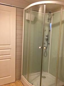 a shower with a glass door in a bathroom at Écologîte in Tressignaux