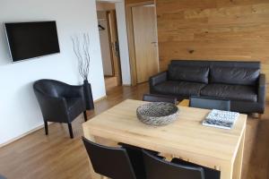 a living room with a table and a couch at Hotel Fr&oacute;n in Reykjav&iacute;k