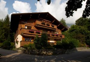 a building with flower boxes on the side of it at Chalet Miravalle in Wengen