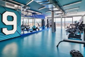 a gym with the letter e on the wall at The Social Hub Florence Lavagnini in Florence