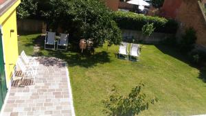 an aerial view of a yard with chairs on the grass at Andoramare B&B in Marina dʼAndora
