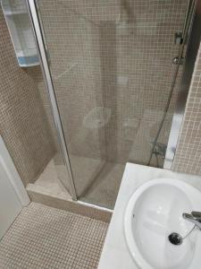a shower in a bathroom with a white sink at Kiana Mirador Fuentebravía in El Puerto de Santa María