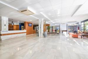 a lobby of a building with couches and tables at azuLine Hoteles Mar Amantis & II in San Antonio Bay +49 photos