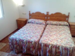 a bed with a quilt on it in a bedroom at El Molino in Ruidera
