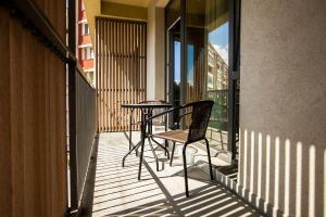 a patio with a table and chairs on a balcony at Victoria Bulevard Hotel in Braşov