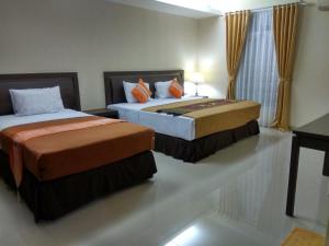 מיטה או מיטות בחדר ב-Puri Ratna Joewita