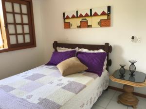 En eller flere senge i et værelse på Condomínio Solar dos Peixes