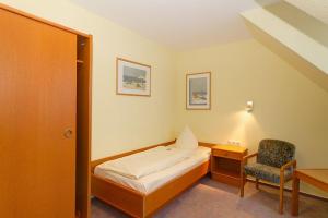 Ένα ή περισσότερα κρεβάτια σε δωμάτιο στο Hotel Tilman