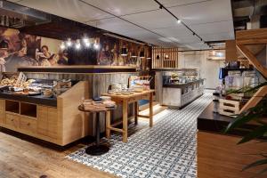 a restaurant with wooden counters and tables in a room at Me and All Hotel Mainz, by Hyatt in Mainz