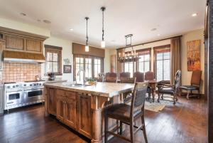 a kitchen with a large island and a table with chairs at Silver Star #04 - 6 Bed Cottage in Park City