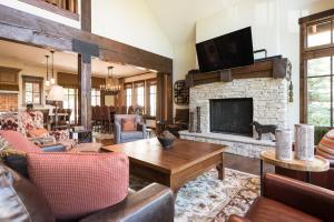 a living room with a fireplace and a tv at Silver Star #04 - 6 Bed Cottage in Park City