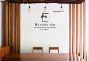 a dining room with a table and two chairs at The Humble Villas in Ban Bang Po