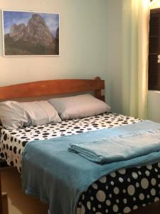 Säng eller sängar i ett rum på Pousada Serra Carioca Friburgo