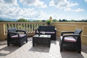 a patio with chairs and a table on a balcony at Residence Colombo in Viareggio