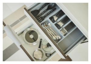 a drawer filled with silver utensils at Grand Baltic Dunes Hotel & SPA in Palanga +88 photos