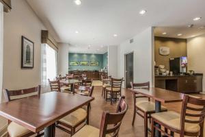 a dining room with wooden tables and chairs at Sleep Inn & Suites Clintwood in Clintwood