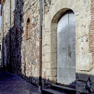 a door on the side of a brick building at Monastero Santa Chiara Guest House in Oristano