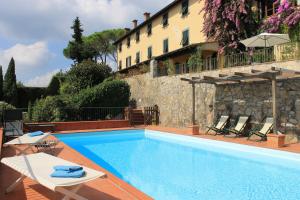 a swimming pool in front of a building at Relais Farinati - Adults only in Lucca