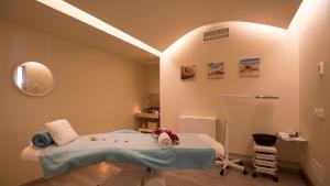 a hospital room with a bed and a lamp at Canyamel Park Hotel & Spa - 4* Sup - Adults only (+16) in Canyamel