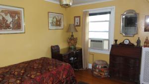 a bedroom with a bed and a window at The Red Rooster in White Plains