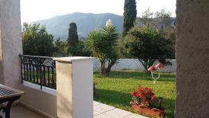 a balcony with a view of a garden at Digkas Apartments in Kato Korakiana