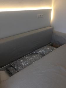 a bed with two pillows in a small room at Privatzeit The green Mile in Leverkusen +15 photos