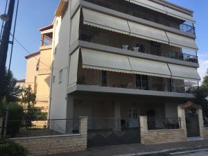 an apartment building with balconies on a street at COZY & QUIET CITY APARTMENT in Tríkala